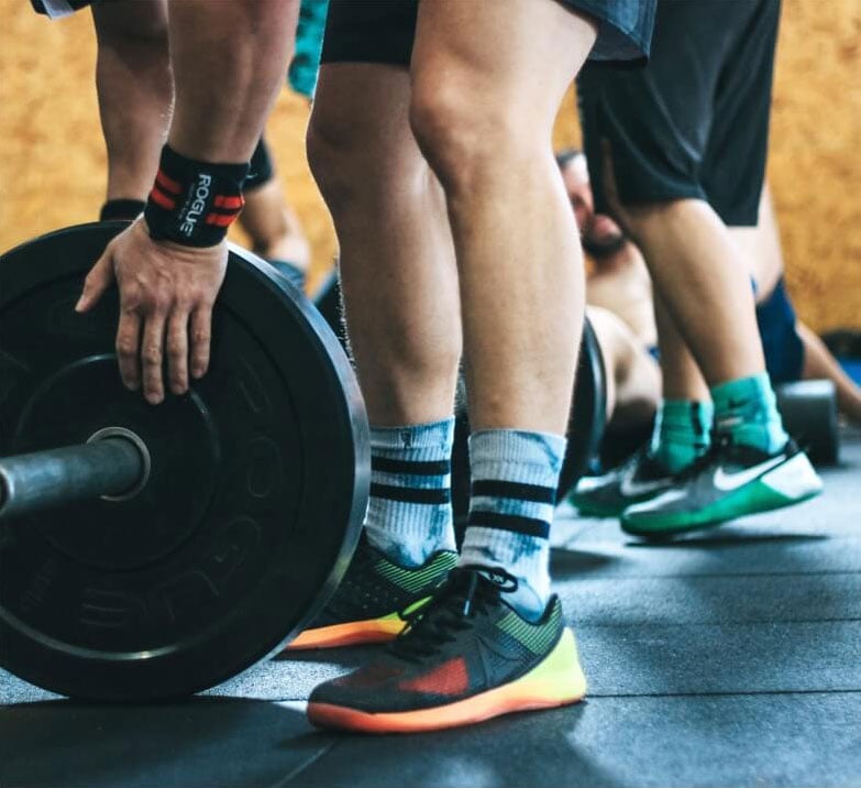 risks of penile fat grafting - image shows young men at the gym with weights